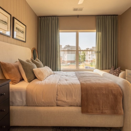 a bedroom with a bed and dressers