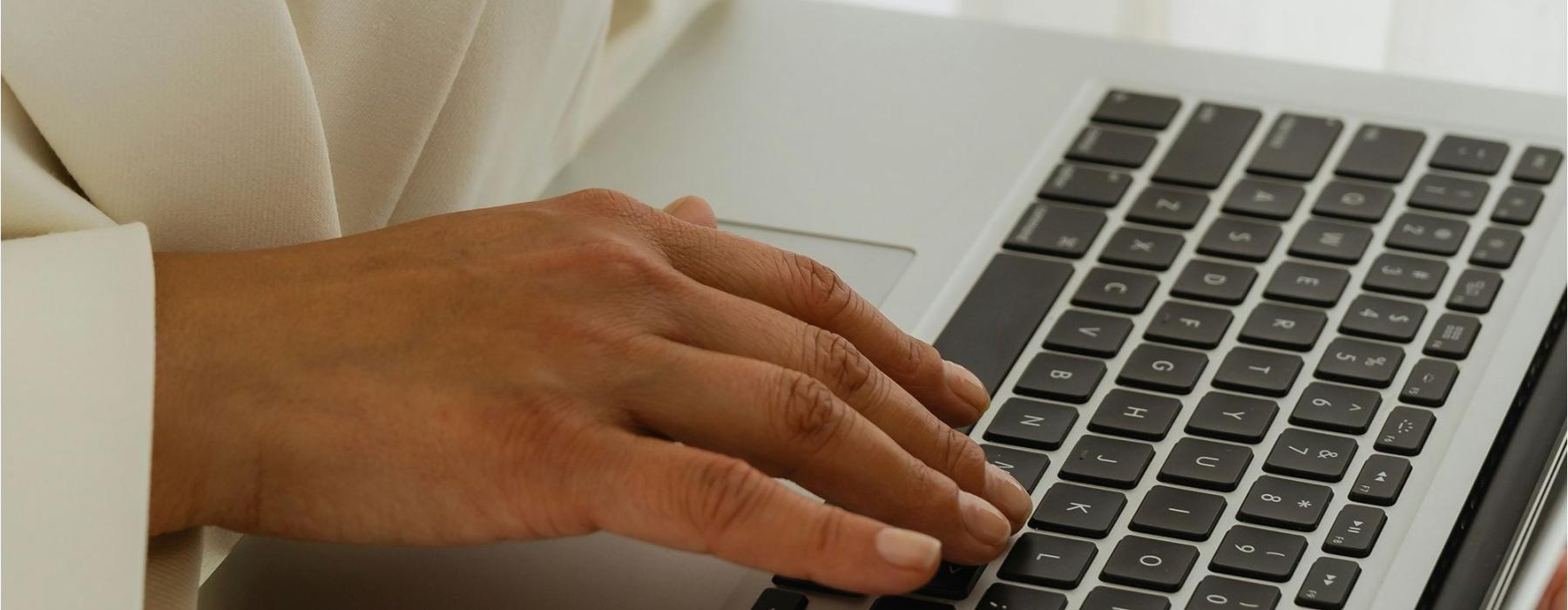 a person typing on a laptop