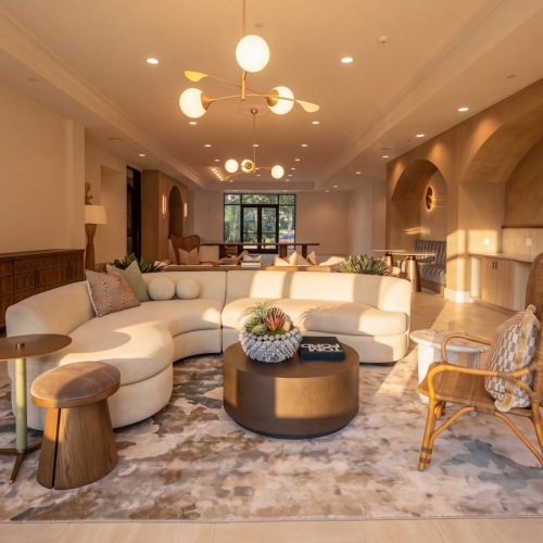 a clubroom with a couch, tables and chairs