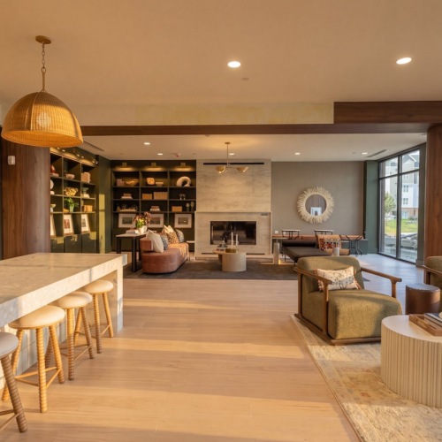 a clubroom with tables, chairs and a plant