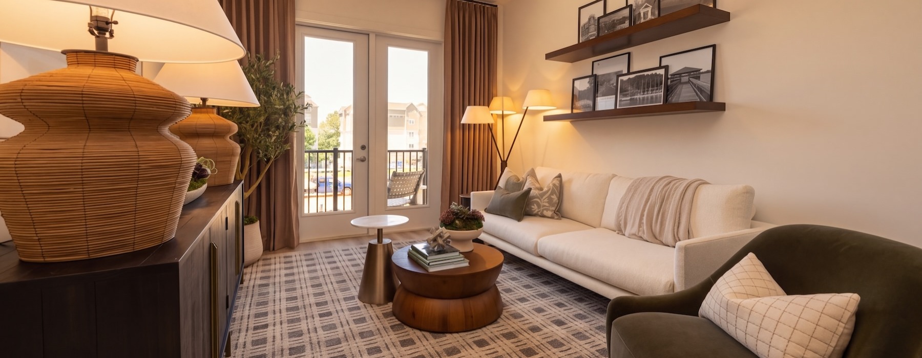 a living room with a couch, tables and a chair